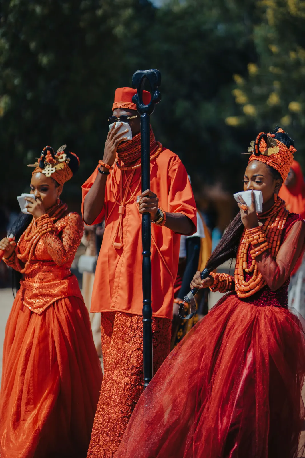 A vibrant traditional African wedding celebration, guests in rich colour